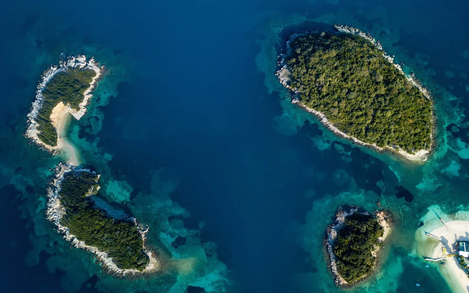 Aerial view of Ksamil Islands showing the blue ionian sea along with the white shore and green islands